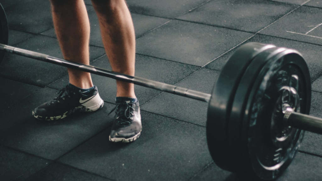 Person Standing Near Dumbbells