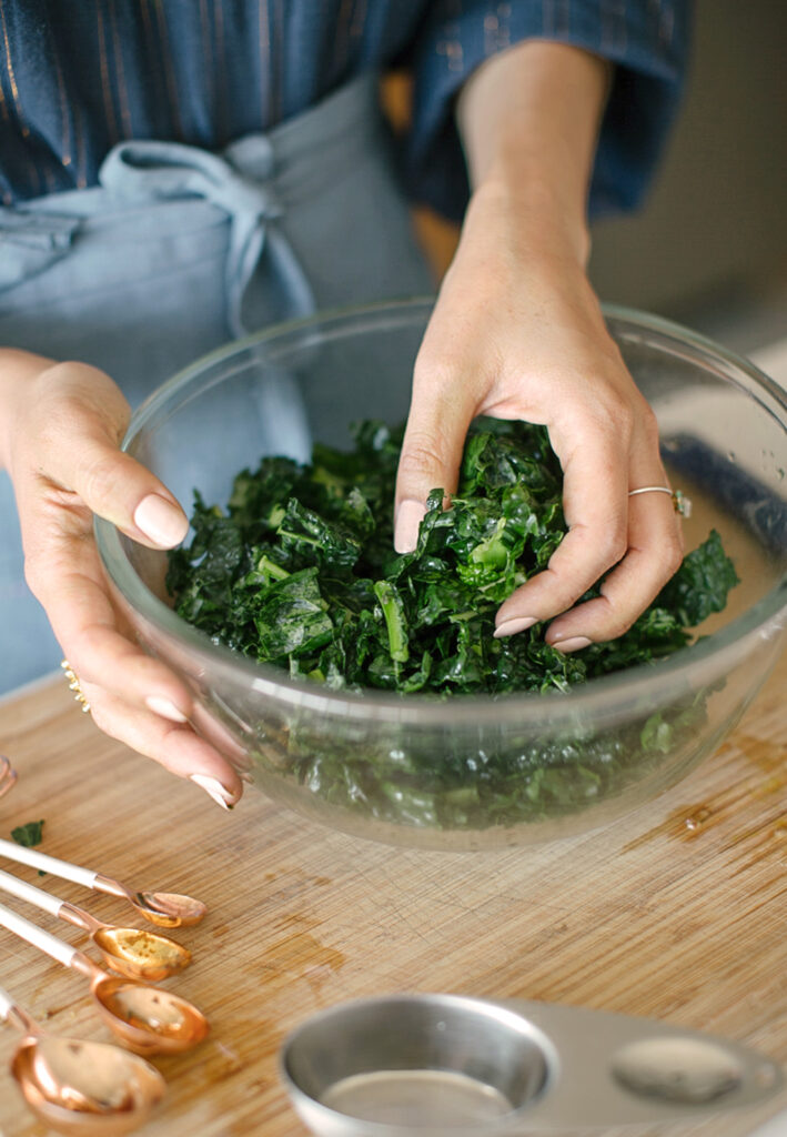 Fresh and organic ingredients will make a meal more delicious and healthy. Here is an image of kale and greens being massaged