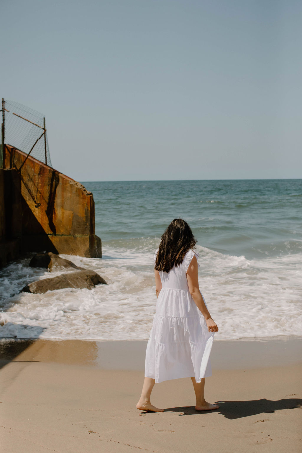 How to heal from traumas and grow as a person. Image is of a young woman facing the ocean.