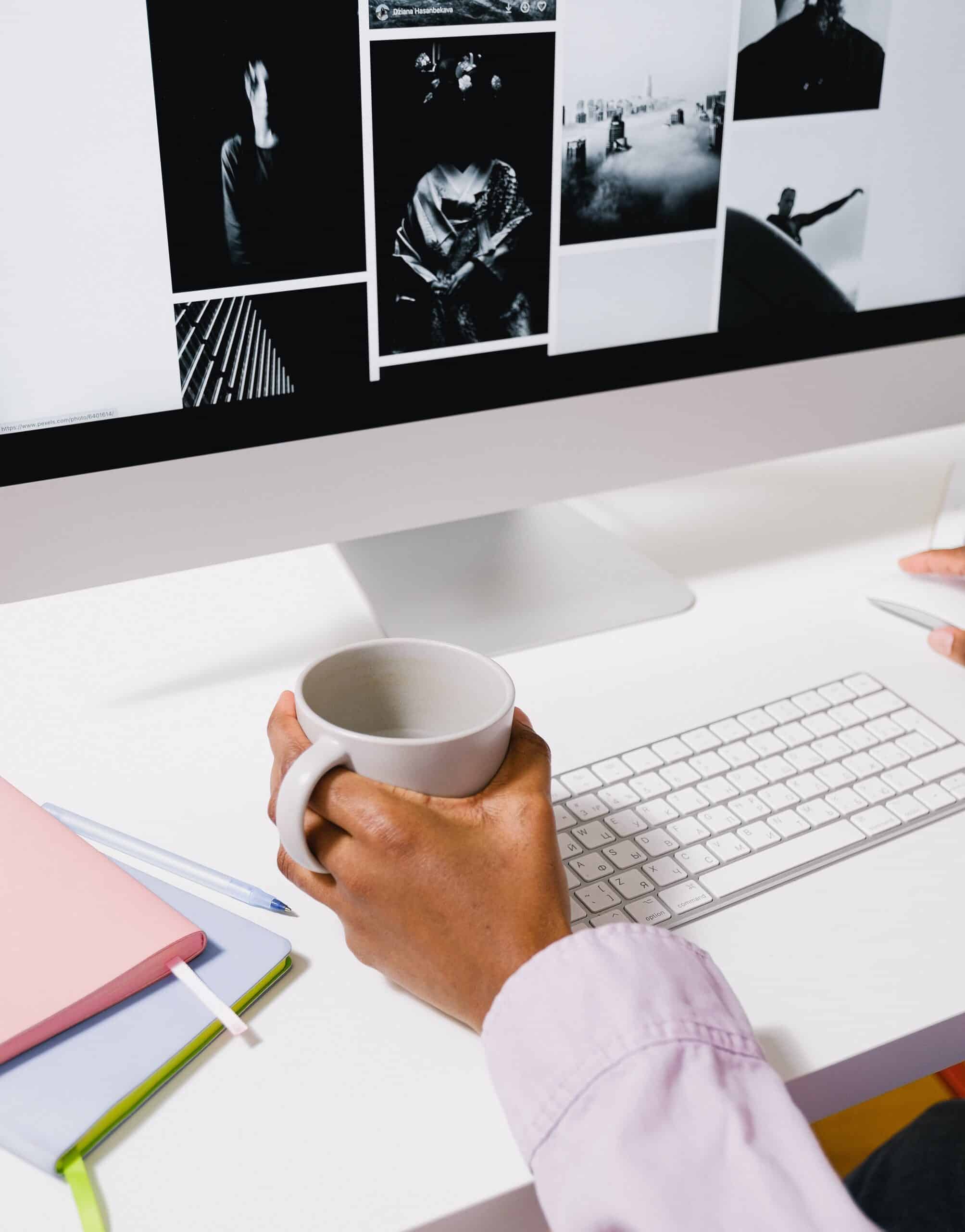 This is for a guide on tech accessories that free up your time. The picture is of a person holding a coffee mug at a computer.